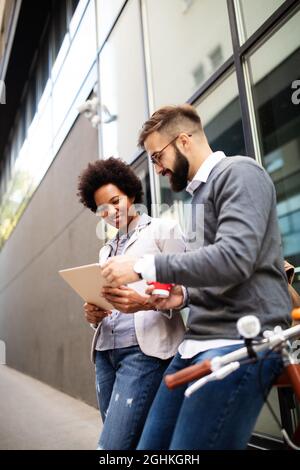 Business people discussing and smiling while walking together outdoor Stock Photo