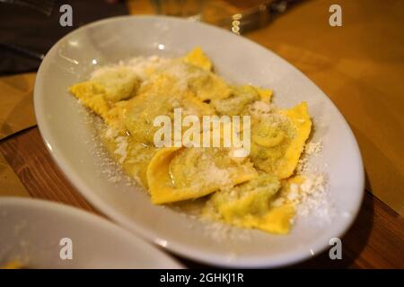 Close up Tortellini d'erbetta,speciality of Parma pasta made from durum egg wheat stuffed with meat, sheep’s and cow’s milk ricotta cheese, spinach Stock Photo