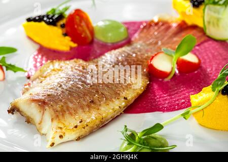 Fish dish - fried fish fillet and vegetables Stock Photo