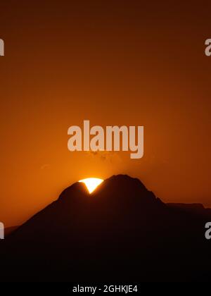 A sunset with the silhouette of the Pedraforca, a famous mountain in ...
