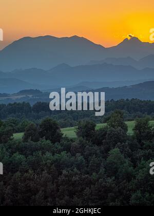 A sunset with the silhouette of the Pedraforca, a famous mountain in ...