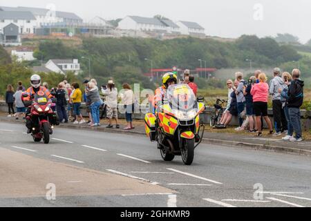 Road race safety marshals on motorbikes riding into Newquay in Cornwall during the opening stage of the iconic Tour of Britain 2021 - known as The Gra Stock Photo