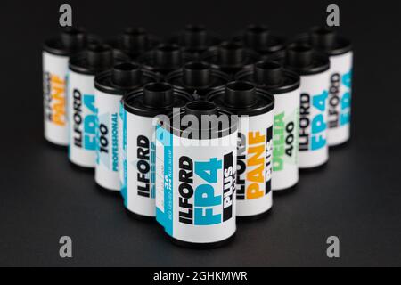 VALENCIA, SPAIN - SEPTEMBER 06, 2021: Pile of black and white 35mm film rolls, made by Ilford . Film photography revival concept Stock Photo