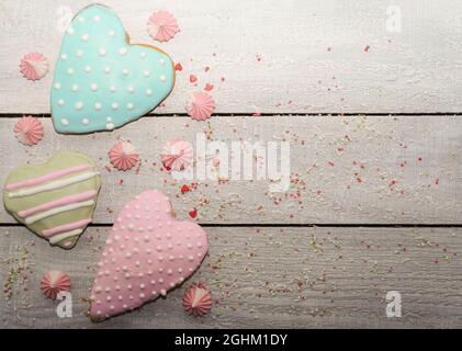 Easter cooking baking background with pastel colored easter cookies and meringue. Wooden rustic background, flatlay banner copy space. Happy Mothers D Stock Photo
