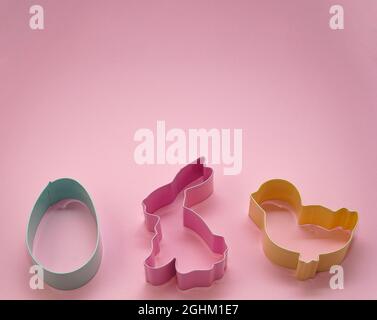 Easter pastel colored Cookie Cutters on pink pastel background. Easter Egg Bunny and chick. Happy Easter Day concept. Minimal concept. Copy space for Stock Photo