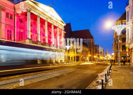 tram in a motion blur at night city center and view on theater, Wroclaw, Poland Stock Photo