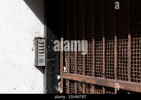 entry system on a building next to an old iron gate, Worthing, West Sussex, UK Stock Photo