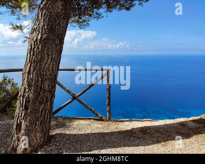 Egremni Beach Panorama observation deck with pine tree. Sunny view on sea turquoise water and scenic blue sky, Lefkada island, Ionian sea coast, Greec Stock Photo