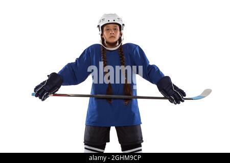 Full-length portrait of child girl hockey player isolated over ice rink Stock Photo