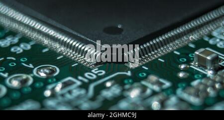 macro photography of integrated circuit in QFP package assembled on printed circuit board Stock Photo