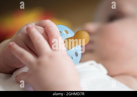 close-up view of hand of baby holding pacifier Stock Photo