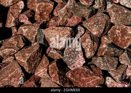 There are many brown and orange colored granite stones. Stone texture. Stock Photo