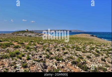 MELLIEHA, MALTA - Sep 21, 2015: The northern coastline of Malta, in the area of Ahrax tal-Mellieha and Armier. Blue sky and sea with green coastal gar Stock Photo