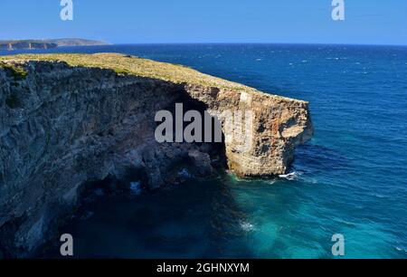 MELLIEHA, MALTA - Sep 21, 2015: Cliffs along the coastline of Malta, in the area of Ahrax tal-Mellieha and Armier. Blue sky and sea with green coastal Stock Photo