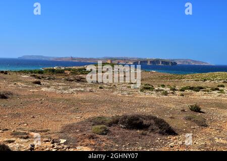 MELLIEHA, MALTA - Sep 21, 2015: The northern coastline of Malta, in the area of Ahrax tal-Mellieha and Armier. Blue sky and sea with green coastal gar Stock Photo