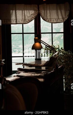 Vertical shot of a vintage decorated office with a mirror view of the sea Stock Photo