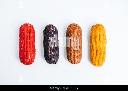 Multicolored eclairs isolated on white background. Stock Photo