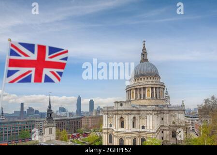 London, England - Sep. 7, 2021 - A Union Jack flag flies in the wind with a view of St Paul's Cathedral in the background. Stock Photo