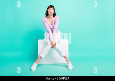 Full length body size photo woman upset unhappy wearing fashionable clothes looking copyspace isolated bright teal color background Stock Photo