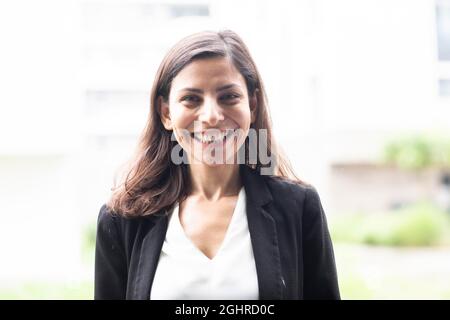 Middle aged serious manager standing outside and laughing, Freiburg, Baden-Wuerttemberg, Germany Stock Photo