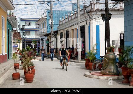 Street Scene, Caribbean, People, Cubans, Cyclists and Church Bells in the Street of the Bell, Calle Honorato, Old Town, Sancti Spiritus, Central Stock Photo