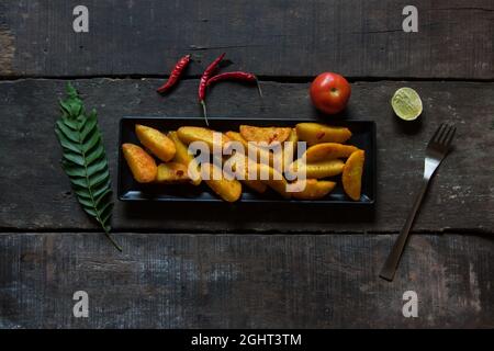 Snacks item baked and crispy potato wedges served with ingredients. Top view. Stock Photo