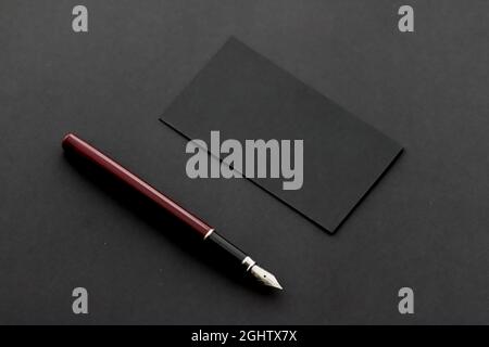 Blank black business card for mockup and pen on dark background, luxury branding and corporate identity design Stock Photo