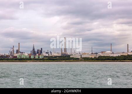 Fawley oil refinery, the largest oil refinery in the UK, on Southampton Water, Hampshire, UK from the sea - owned by Esso Petroleum Company Limited Stock Photo
