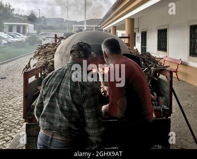 Baking bread in a traditional clay oven in Alentejo, Portugal. Stock Photo