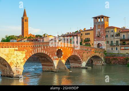 View on Bridge Ponte Pietra in Verona on Adige river, Veneto region, Italy. Summer morning landscape. Travel destination Stock Photo