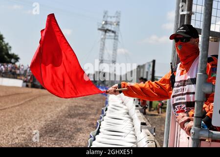 Circuit atmosphere - marshal waves a red flag.  16.07.2021. Formula 1 World Championship, Rd 10, British Grand Prix, Silverstone, England, Practice Day.  Photo credit should read: XPB/Press Association Images. Stock Photo
