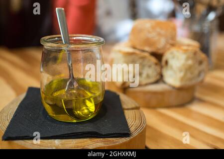 Igualada, Spain, February 2019. Bread with olive oil severed at Somiatruites restaurant in Igualada, Spain. Stock Photo