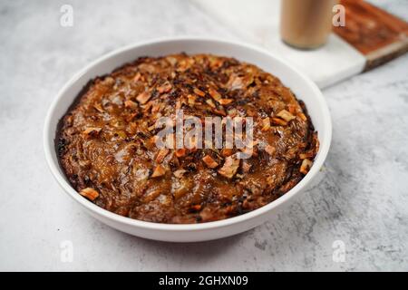 Kalthappam or Kalathappam- Malabar special Steamed sweet rice cake with shallots jaggery and dry coconut chunks Stock Photo
