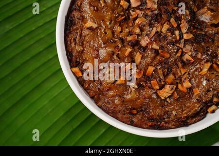 Kalthappam or Kalathappam- Malabar special Steamed sweet rice cake with shallots jaggery and dry coconut chunks Stock Photo