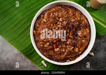 Kalthappam or Kalathappam- Malabar special Steamed sweet rice cake with shallots jaggery and dry coconut chunks Stock Photo