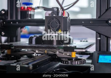 The 3D printer prints black plastic model. modern technology. Stock Photo