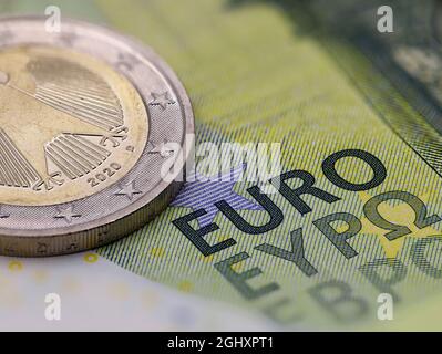 close up of euro banknote with coin, selective focus on the word EURO Stock Photo