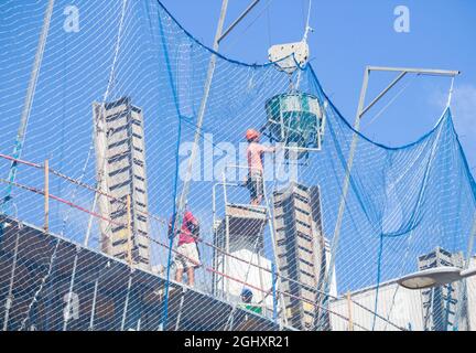 worker, workman, pouring concrete on building site. Stock Photo