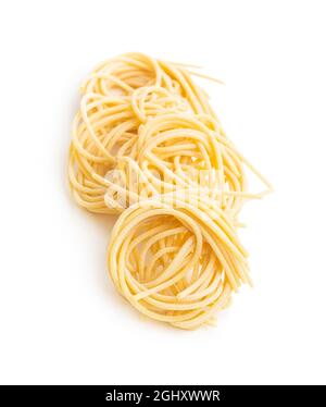 Italian pasta nest. Uncooked spaghetti nest isolated on white background. Stock Photo