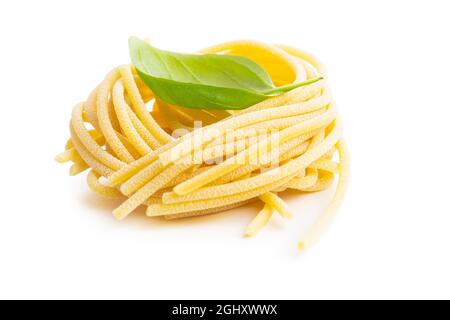 Italian pasta nest. Uncooked spaghetti nest isolated on white background. Stock Photo