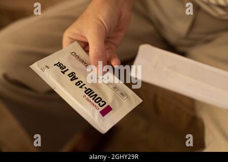 Woman holding a Covid-19 self-test kit Stock Photo