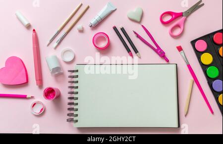 Back to school kids creativiy concept. School supplies and blank notebook on pink color background, space for text, top view Stock Photo