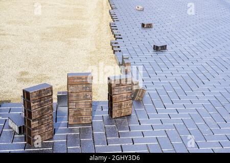 laying of modern beautiful design cobblestones on a flat prepared surface Stock Photo