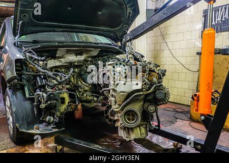 dismantling a damaged engine from a car with the help of a folding hydraulic  crane Stock Photo - Alamy