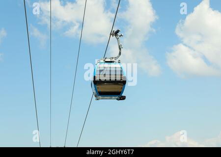 Cable car cabins against amazing sky and clouds. Cableway, Stock Photo