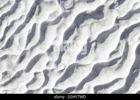 Gray texture background of Pamukkale calcium travertine in Turkey, pattern of diagonal waves, close-up. Stock Photo