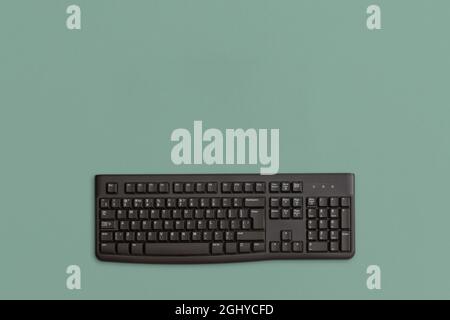 Computer black keyboard on green background Stock Photo