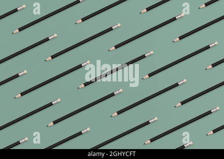 Pattern composition of black pencils on a green background. Top view. Flat lay. Back to school concept. Stock Photo