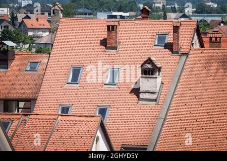 Picture of an old residential house from central europe with a brand new roof recently renovated and some roof windows, or sky;ight windows. Stock Photo