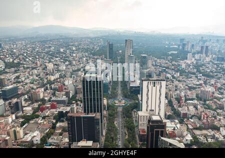 Aerial view of the Angel of Independence surrounded by greenery and commercial and financial building in Mexico City during day Stock Photo